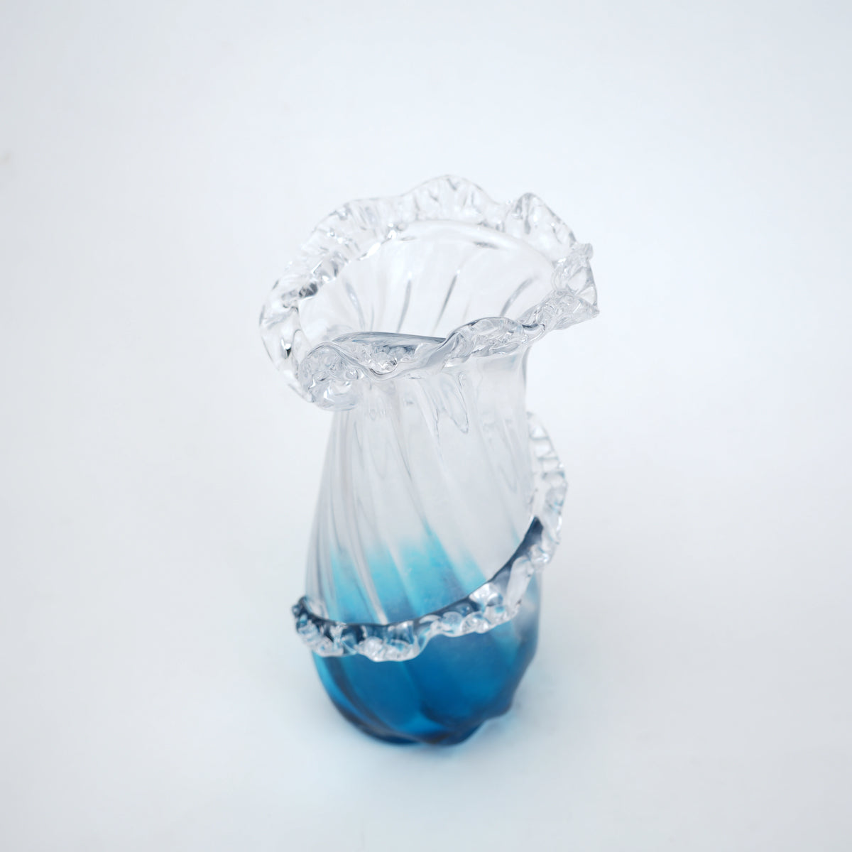 Glass vase with blue gradient on a white background