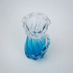 Glass vase with blue and clear design on a white background
