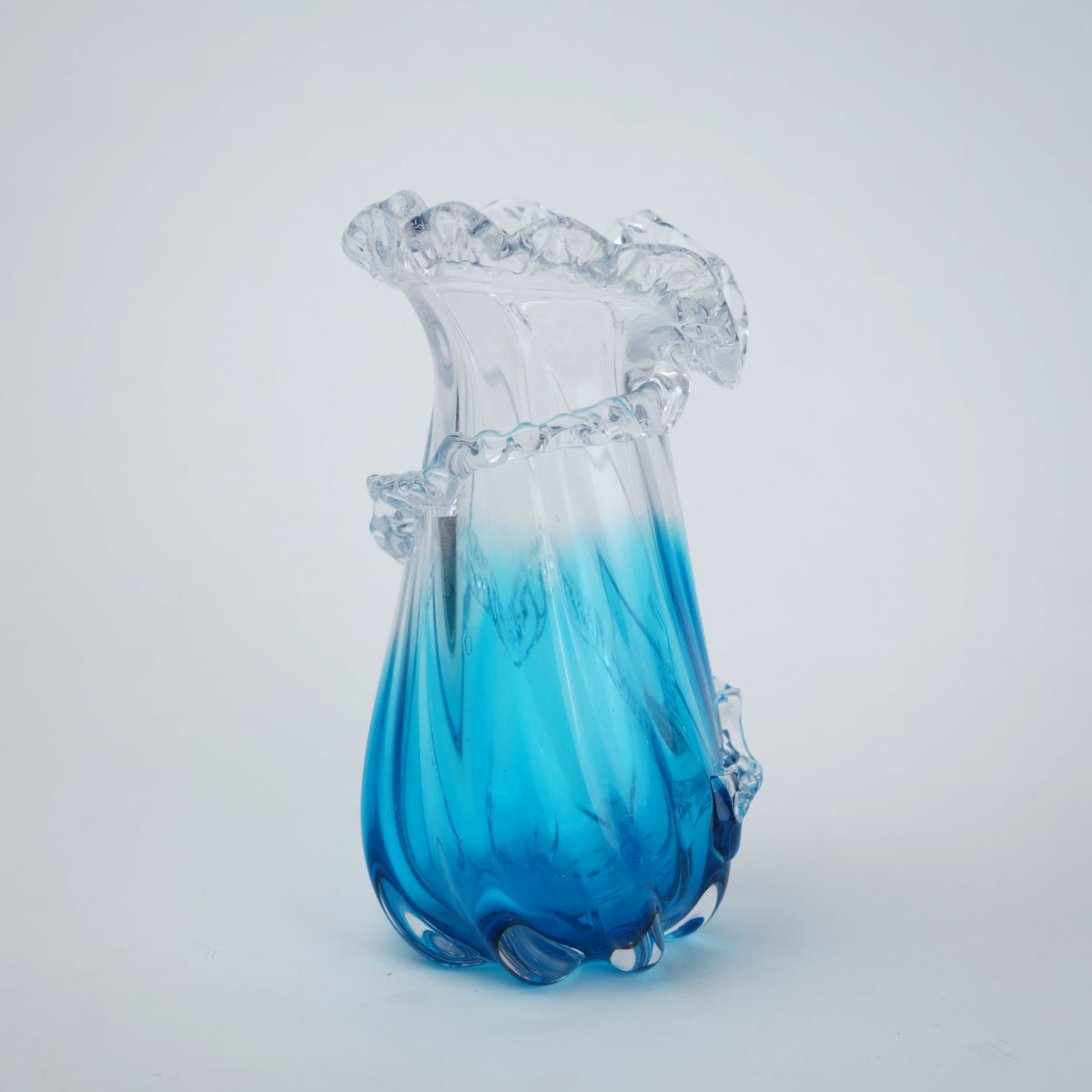 Glass vase with blue and clear design on a white background