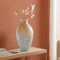 Rounded decorative vase with a narrow neck and marbled finish.