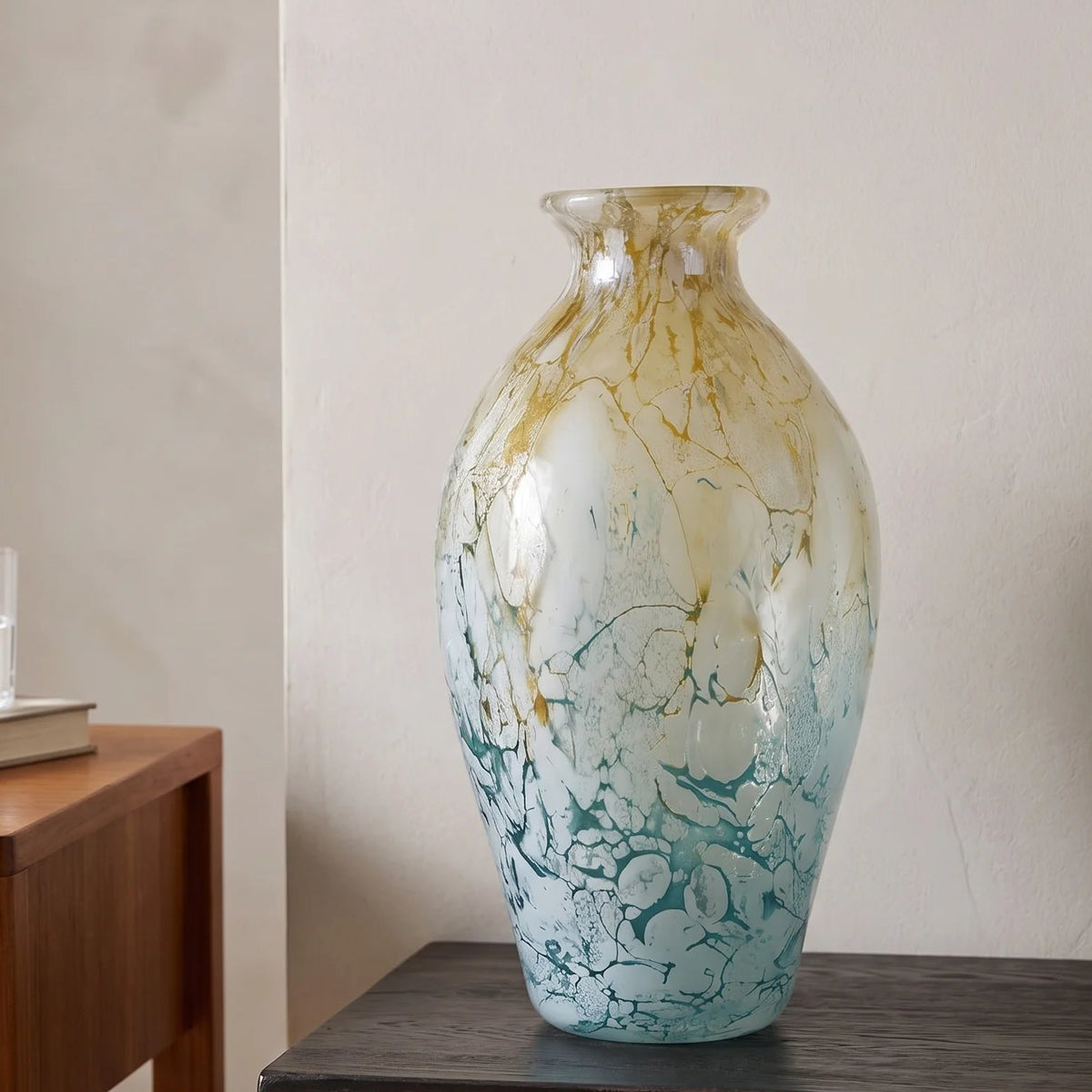 Rounded decorative vase with a narrow neck and marbled finish.