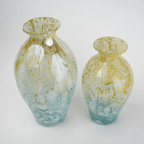 Rounded decorative vase with a narrow neck and marbled finish.
