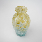 Rounded decorative vase with a narrow neck and marbled finish.