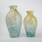 Rounded decorative vase with a narrow neck and marbled finish.