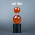 amber glass orb candle holder with black base modern decor