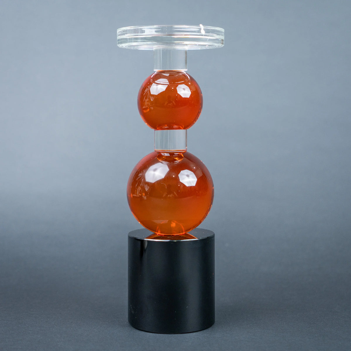 amber glass orb candle holder with black base modern decor