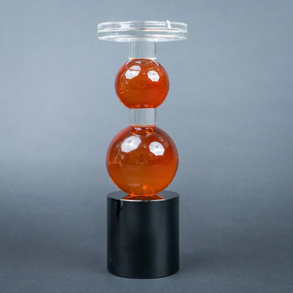 amber glass orb candle holder with black base modern decor