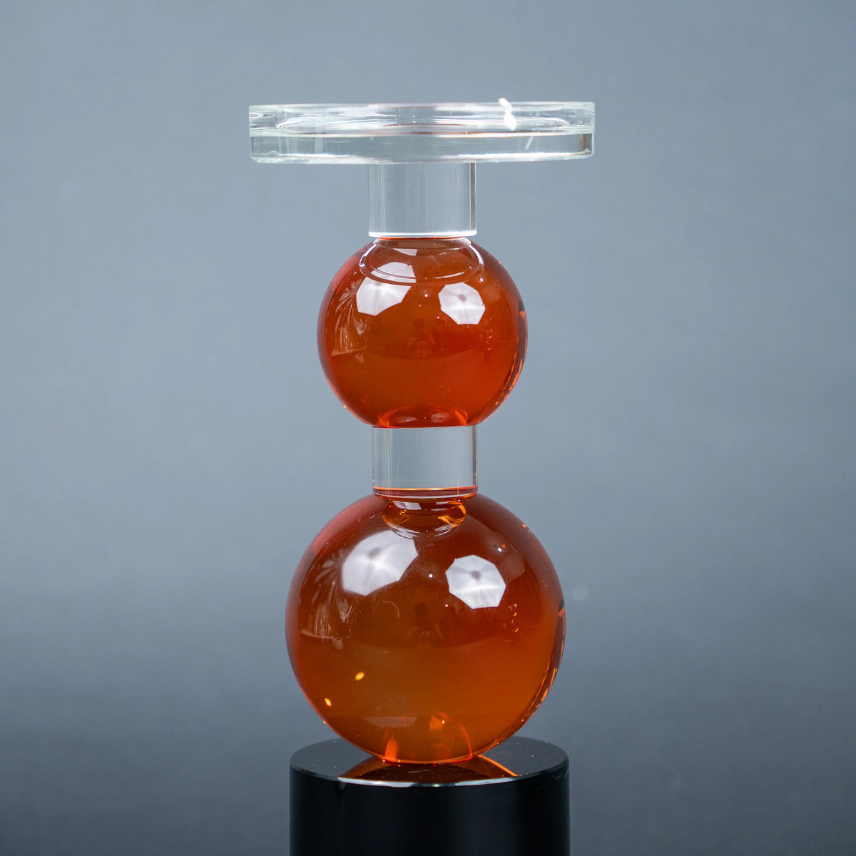 amber glass orb candle holder with black base modern decor
