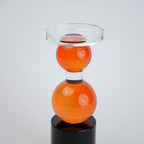amber glass orb candle holder with black base modern decor