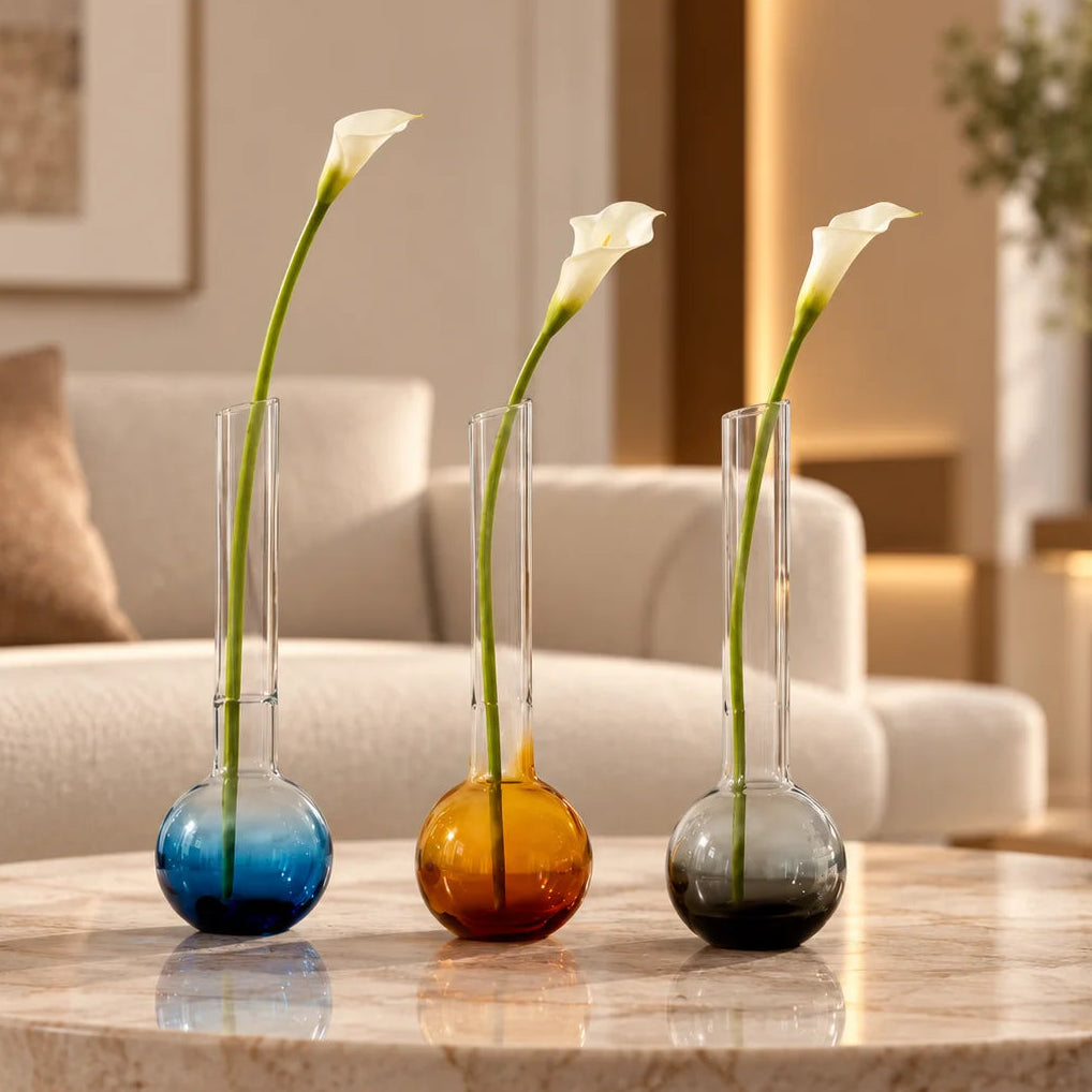 Glass vase with spherical base and elongated cylindrical neck designed for single stem floral arrangements