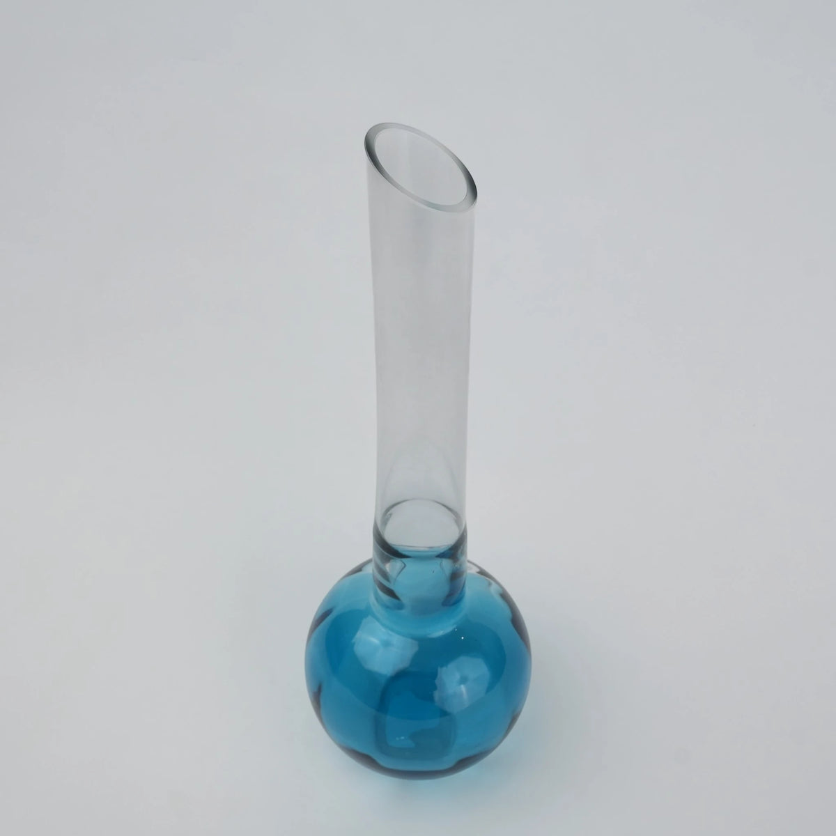 Glass vase with spherical base and elongated cylindrical neck designed for single stem floral arrangements