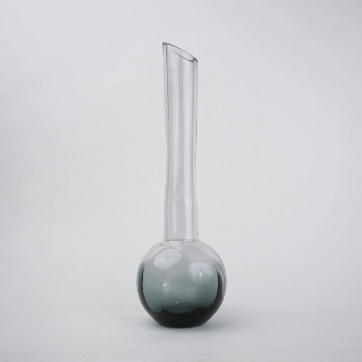 Glass vase with spherical base and elongated cylindrical neck designed for single stem floral arrangements