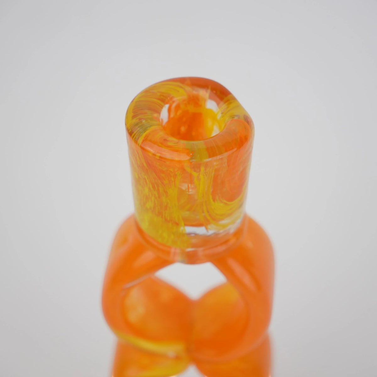 Orange art glass candle holder with geometric open frame and circular ring design