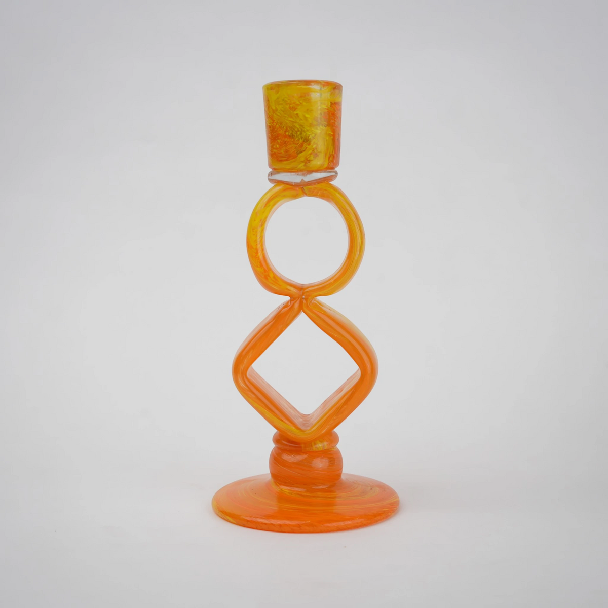 Orange art glass candle holder with geometric open frame and circular ring design