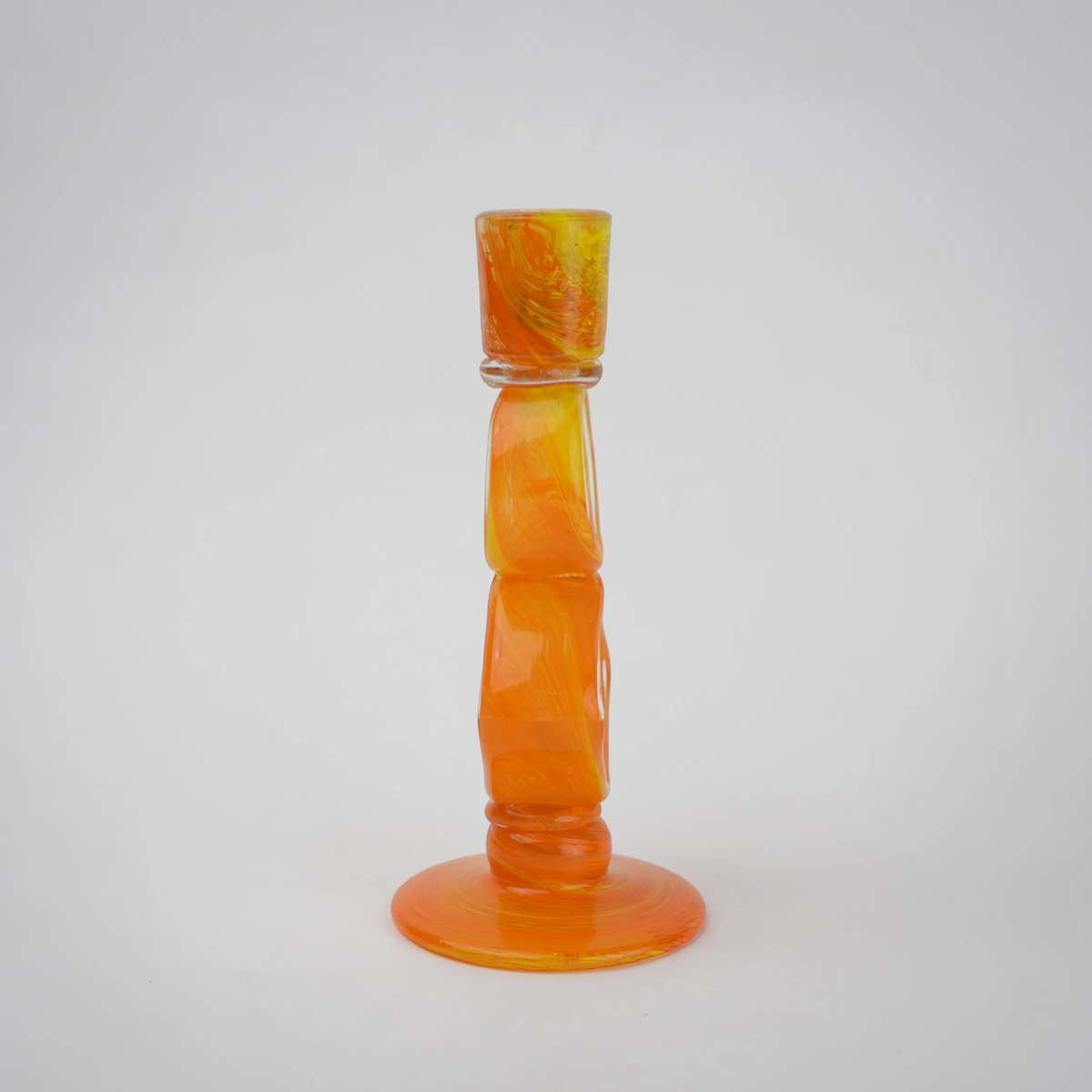 Orange art glass candle holder with geometric open frame and circular ring design