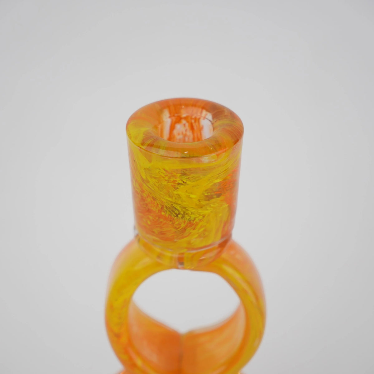 Orange art glass candle holder with geometric open frame and circular ring design