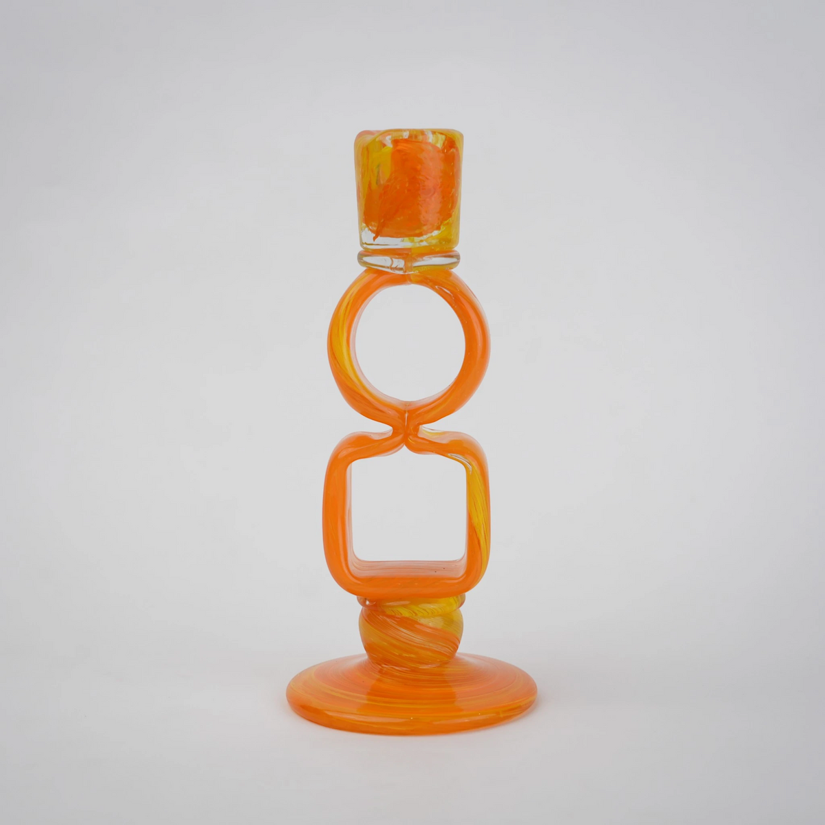 Orange art glass candle holder with geometric open frame and circular ring design