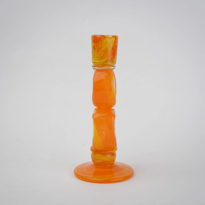 Orange art glass candle holder with geometric open frame and circular ring design