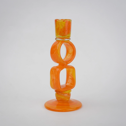 Orange art glass candle holder with geometric open frame and circular ring design