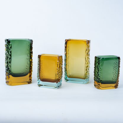 Olive green glass vase with a textured exterior and golden-toned base