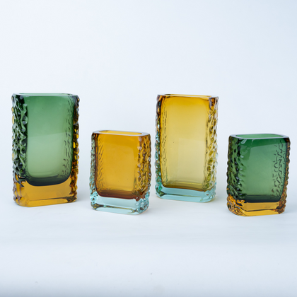 Olive green glass vase with a textured exterior and golden-toned base