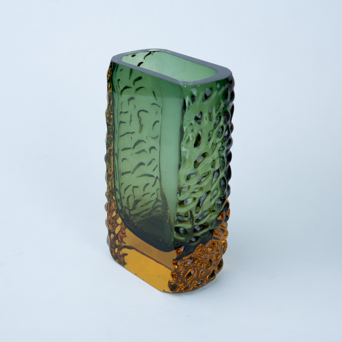 Olive green glass vase with a textured exterior and golden-toned base