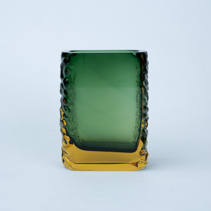 Olive green glass vase with a textured exterior and golden-toned base