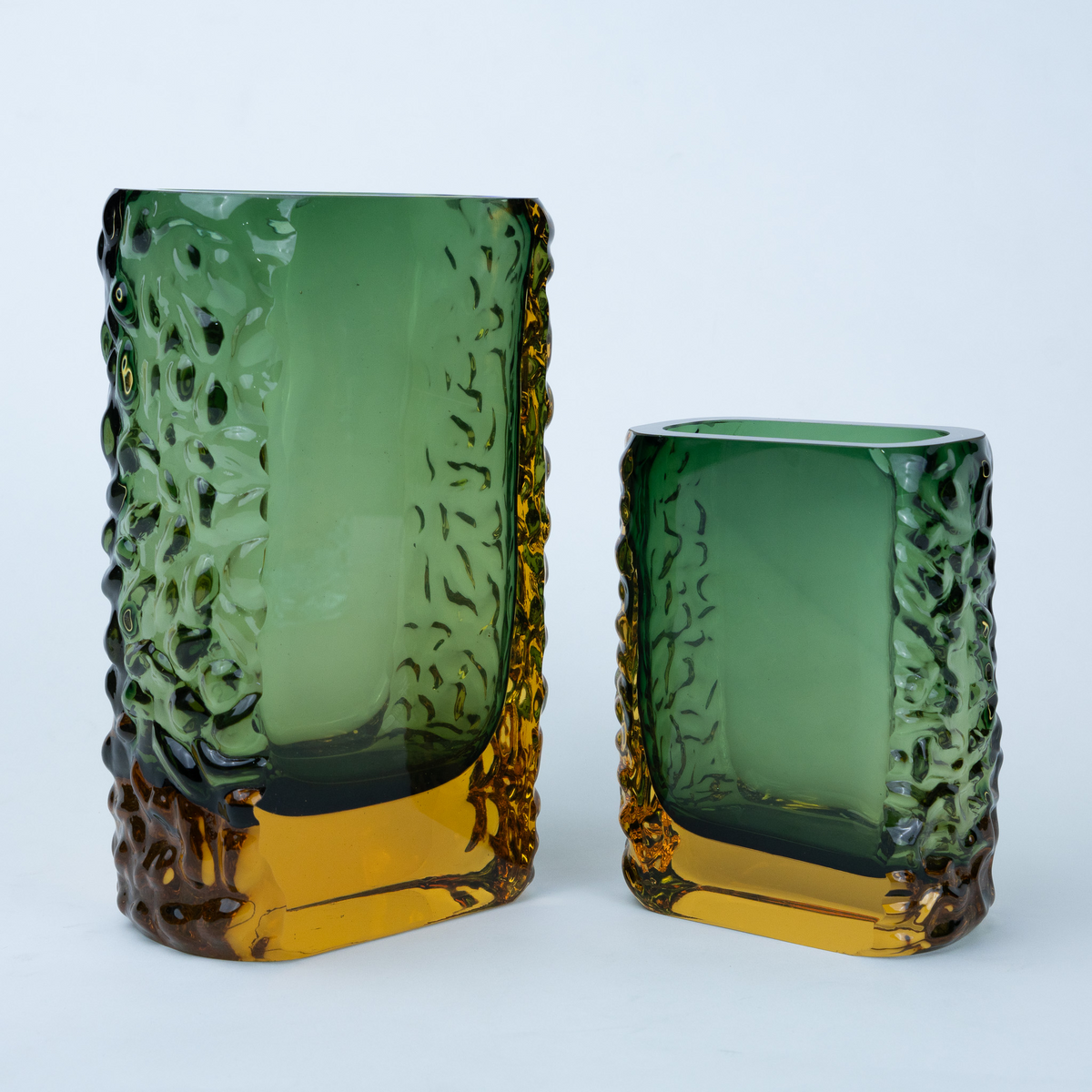 Olive green glass vase with a textured exterior and golden-toned base