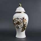 White ceramic jar with gold leaf design and lid