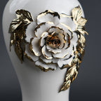 White ceramic jar with gold leaf design and lid