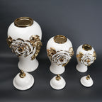 White ceramic jar with gold leaf design and lid