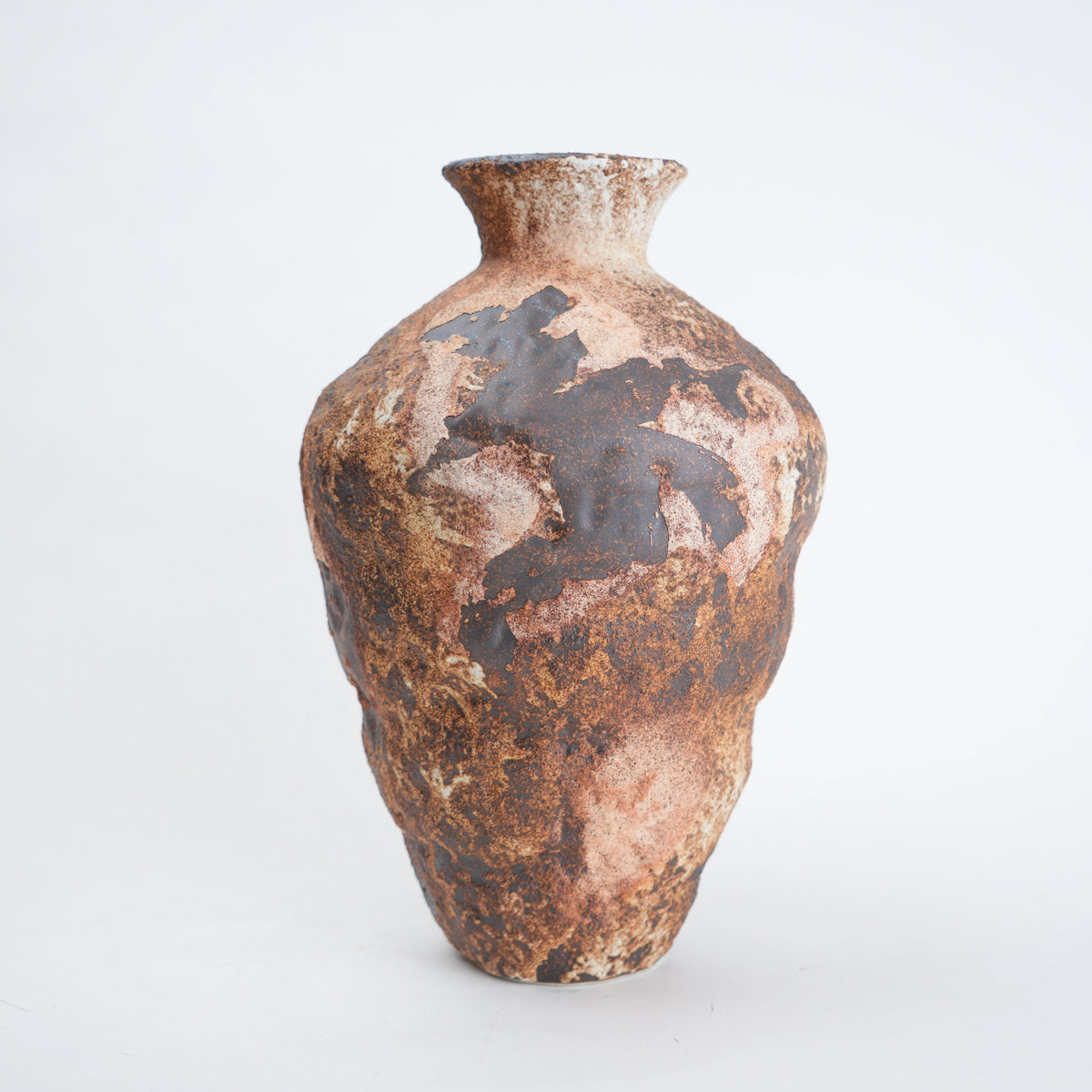 Brown ceramic vase with textured surface on a white background