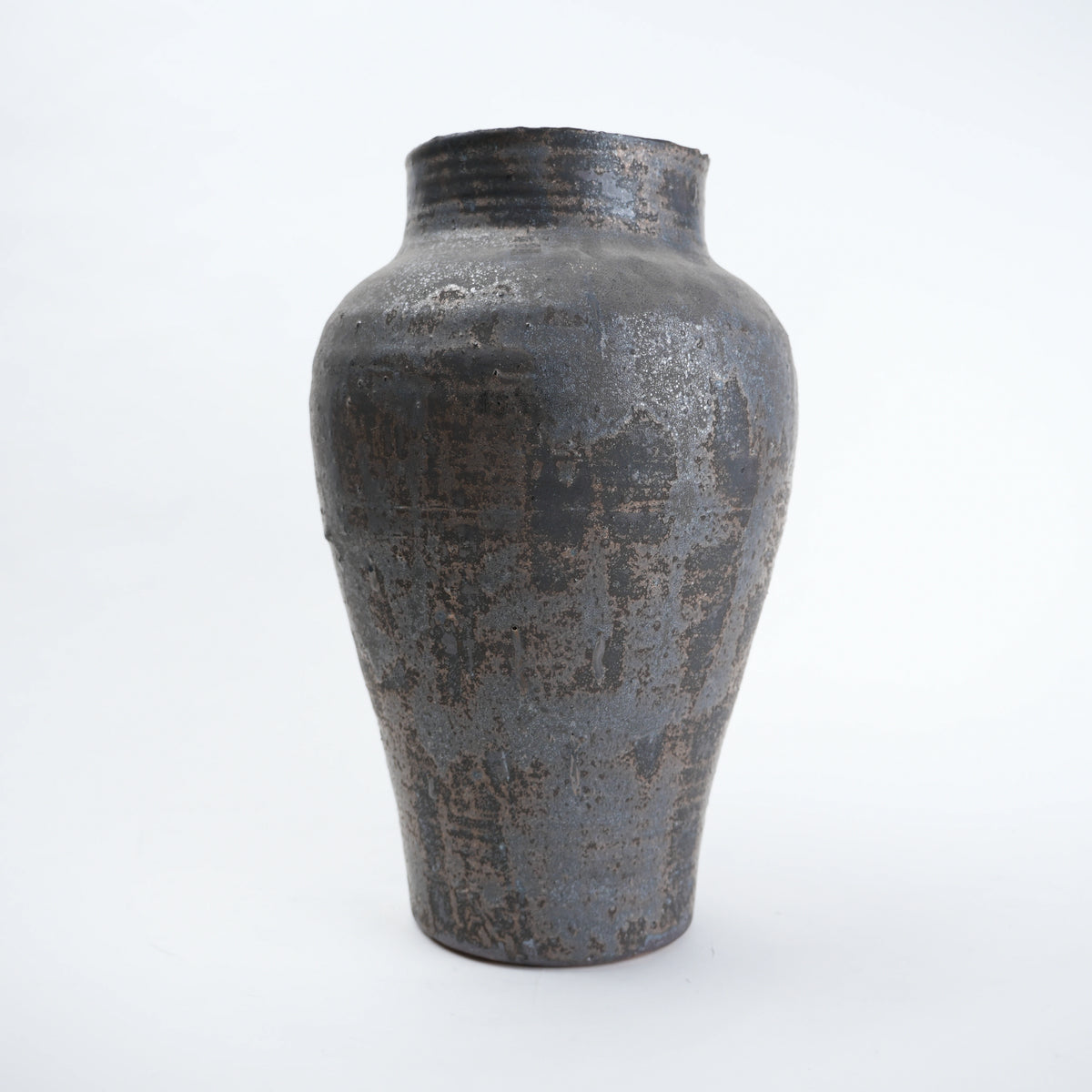 Textured black ceramic vase on a white background