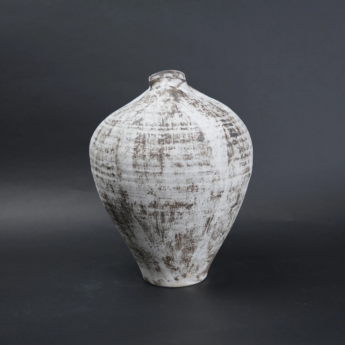Textured ceramic vase on a dark background