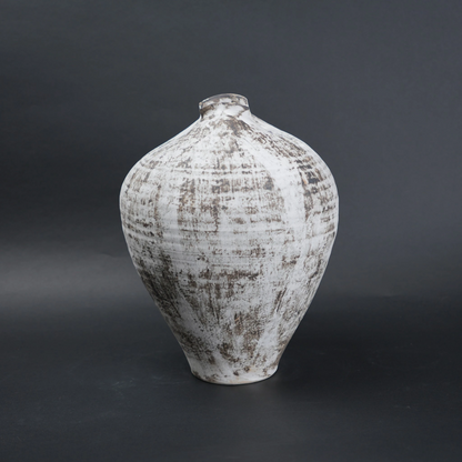Textured ceramic vase on a dark background