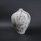 Textured ceramic vase on a dark background