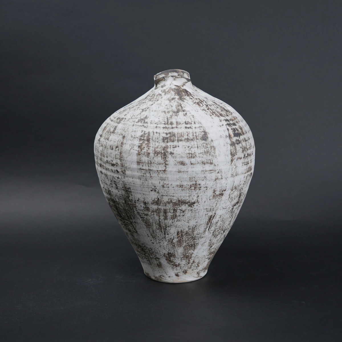 Textured ceramic vase on a dark background