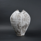 Textured ceramic vase on a dark background