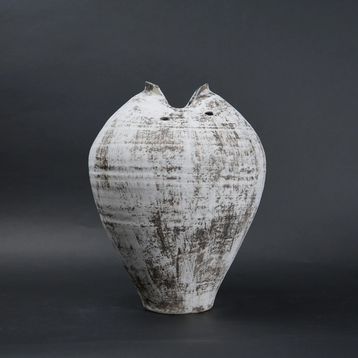 Textured ceramic vase on a dark background