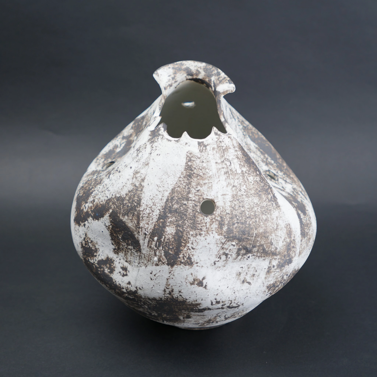 Distressed ceramic vase on a dark background