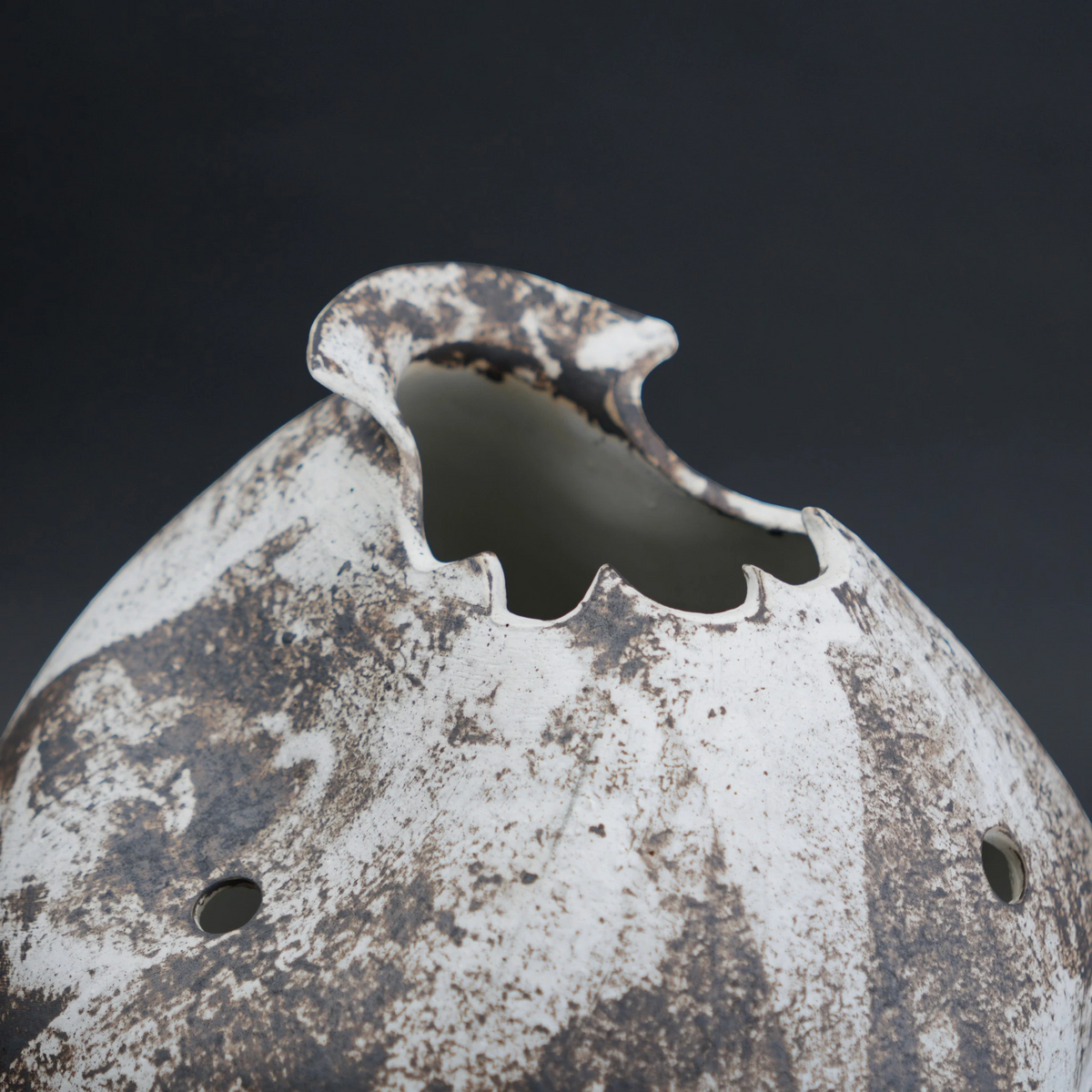Rust-covered metal object with a dark background