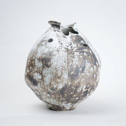 Distressed ceramic vase on a white background