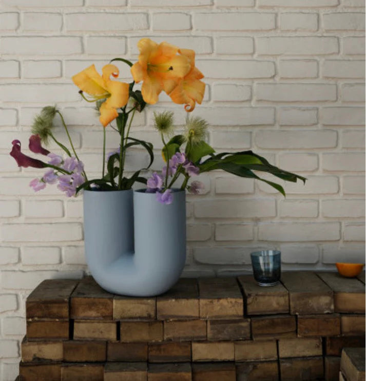 Powder blue dual curve vase w/ orange lily