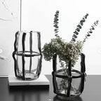 Ribbed vase pair w/ eucalyptus, dark table