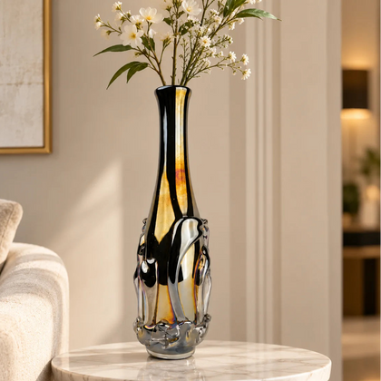Smoked chrome iridescent glass vase with elongated neck and reflective finish.