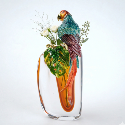 Glass vase with a parrot design and floral elements on a white background