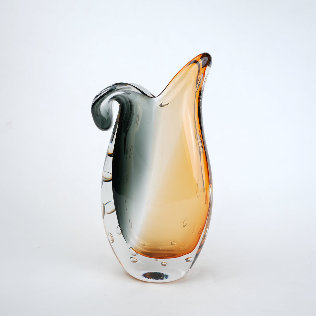 Glass vase with gradient color from gray to orange on a white background