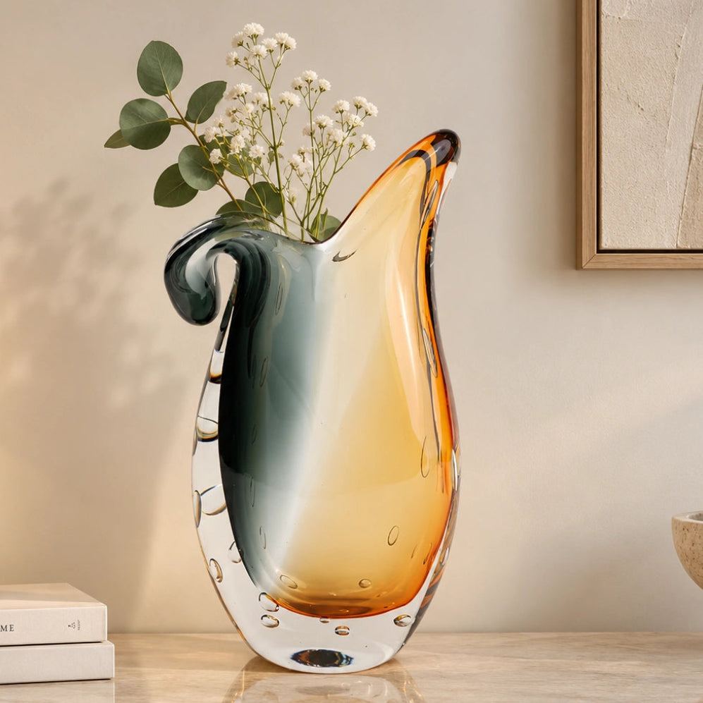 Glass vase with gradient color from gray to orange on a white background