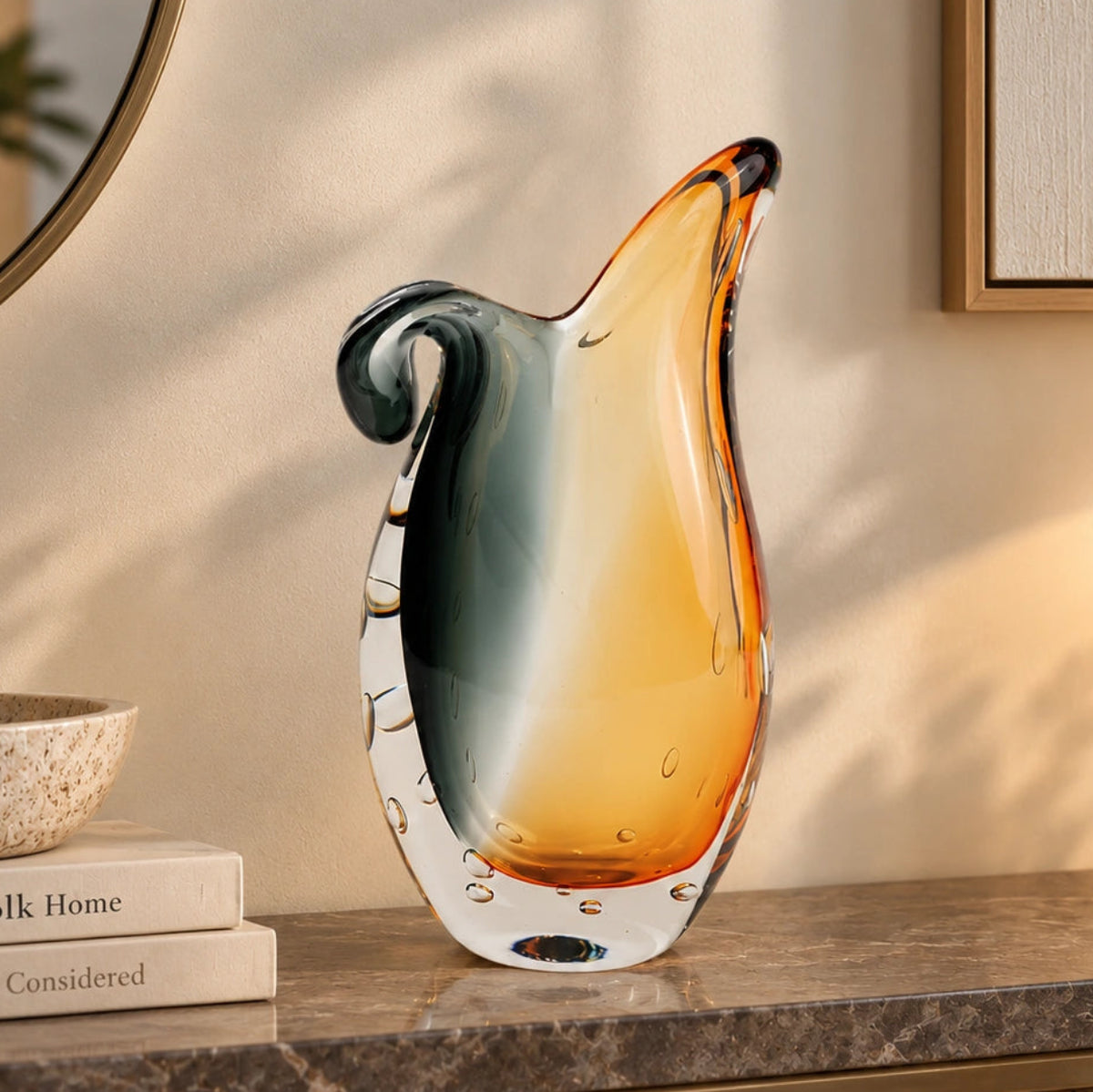 Glass vase with gradient color from gray to orange on a white background