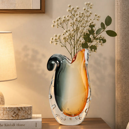 Glass vase with gradient color from gray to orange on a white background